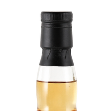 Load image into Gallery viewer, Close-up of the black cap, neck seal and whisky fill level on the Ardmore bottle