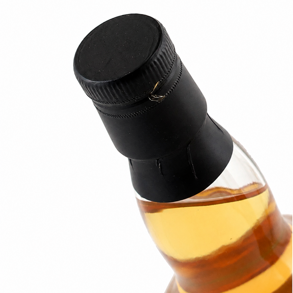 Angled close-up of the Ardmore bottle's black cap and neck seal