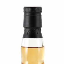 Load image into Gallery viewer, Close-up of the black cap, neck seal and whisky fill level on the Ardmore bottle