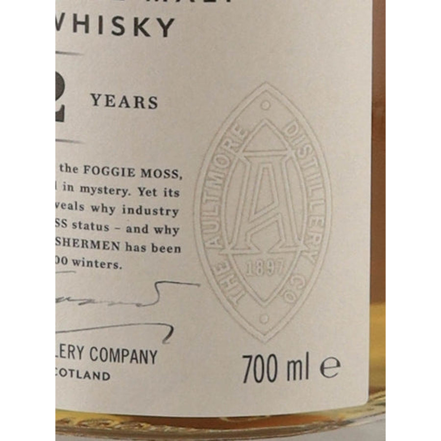 Aultmore 12 Year Old single malt Scotch whisky label close-up showing the distillery emblem and 700ml volume marking