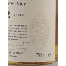 Load image into Gallery viewer, Aultmore 12 Year Old single malt Scotch whisky label close-up showing the distillery emblem and 700ml volume marking