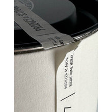 Load image into Gallery viewer, Aultmore 12 Year Old single malt Scotch whisky presentation tube lid close-up showing the paper seal and visible wear