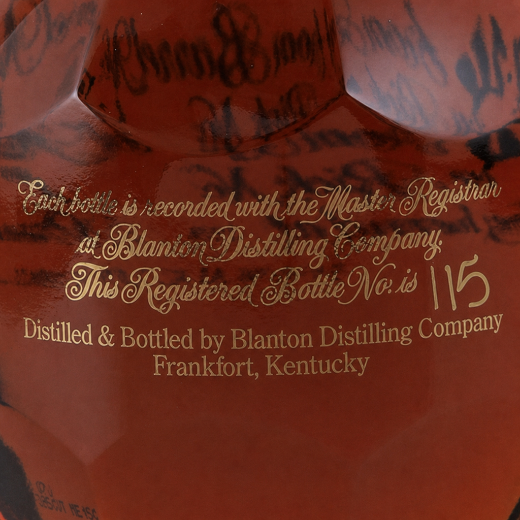 Close-up of the registered bottle number and distillery inscription on a Blanton’s bourbon bottle.