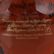 Load image into Gallery viewer, Close-up of the registered bottle number and distillery inscription on a Blanton’s bourbon bottle.