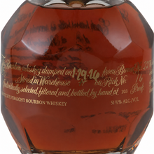 Load image into Gallery viewer, Close-up of the faceted Blanton’s Gold Edition bourbon bottle with amber whiskey and gold lettering.