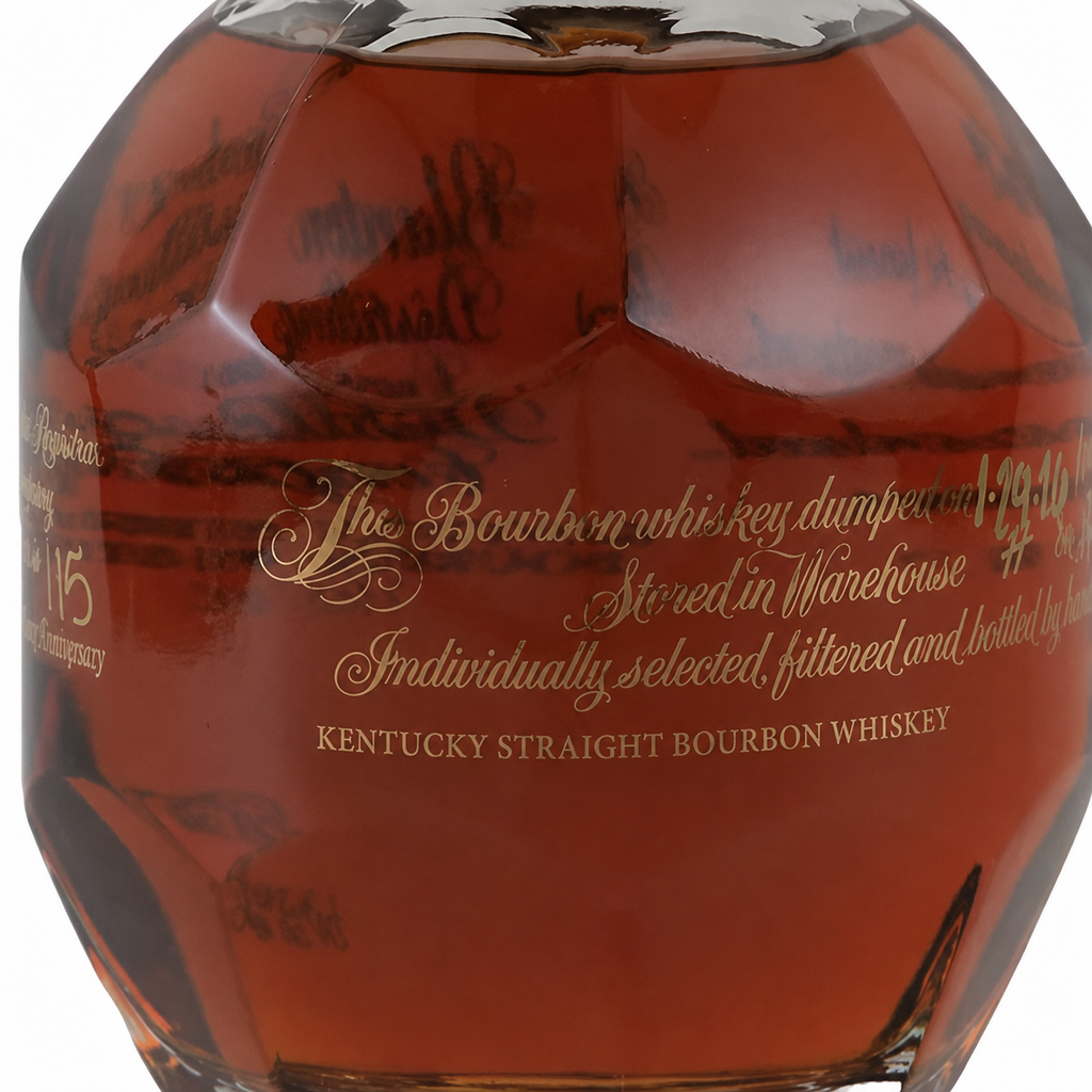 Front close-up of a Blanton’s bourbon bottle featuring faceted glass, amber whiskey and gold lettering.