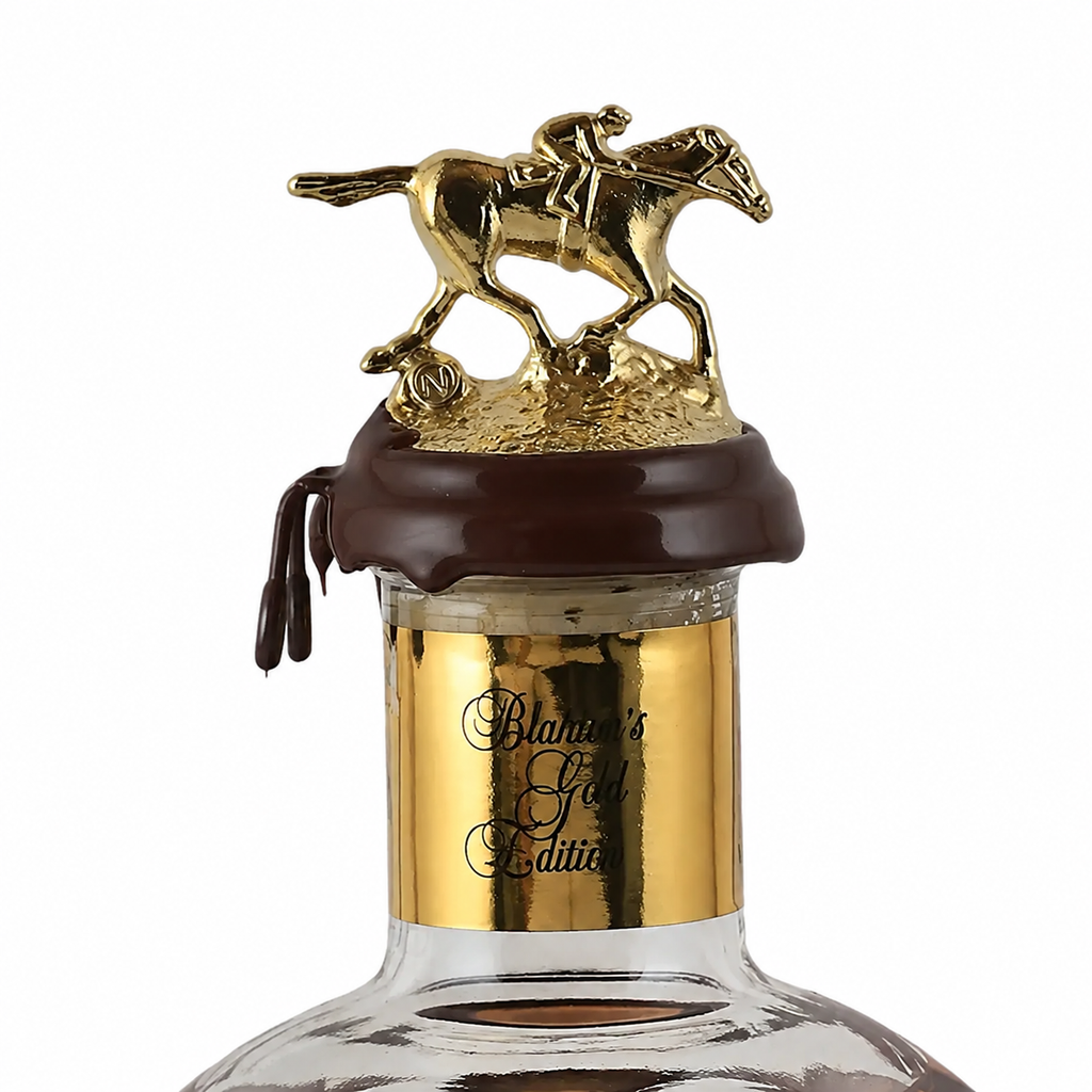 Front view of the Blanton’s gold horse and jockey bottle stopper with a dark brown wax seal.
