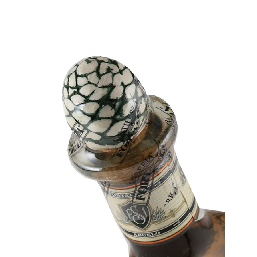 Fortaleza Anejo tequila, angled view of the agave-shaped stopper