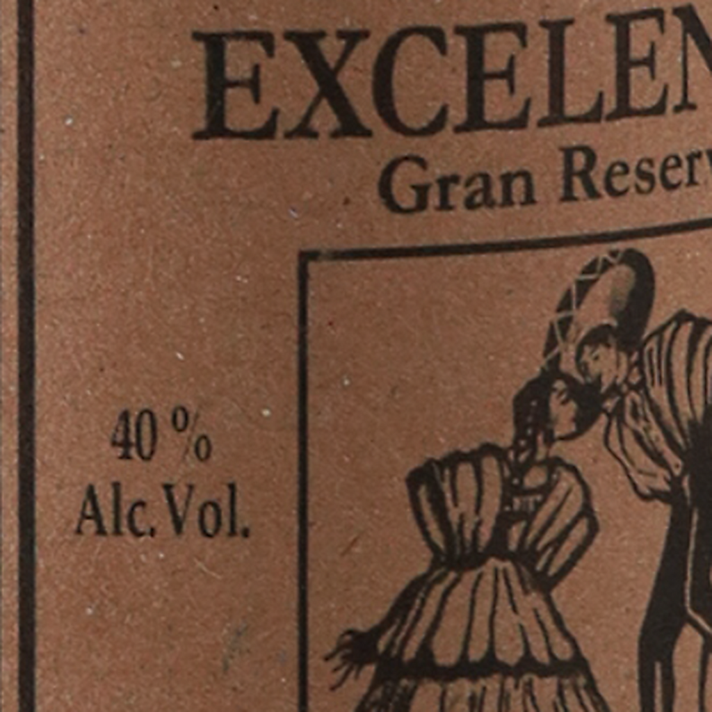 Close-up of a brown paper label with black printed text reading 'EXCELEN.