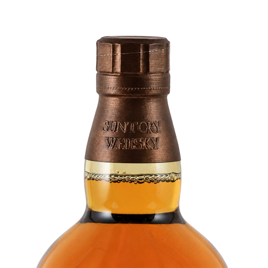 Suntory Whisky bottle with a metallic cap on a gray background
