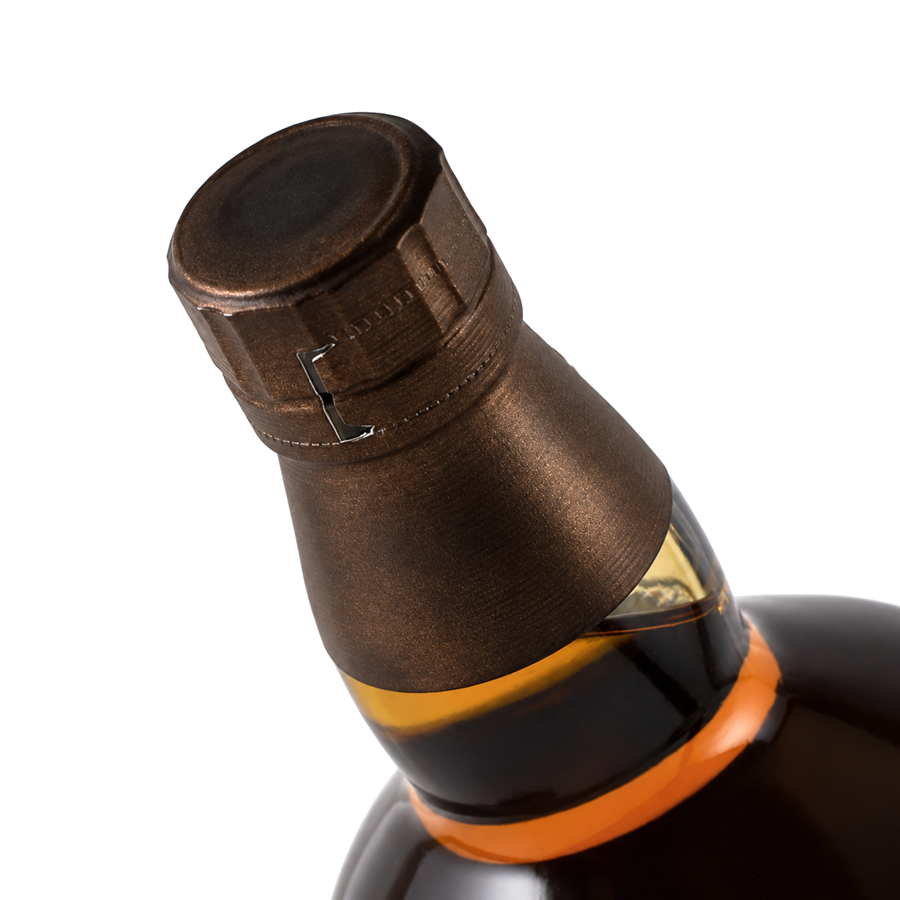 Close-up of a wine bottle with a bronze foil cap on a light gray background