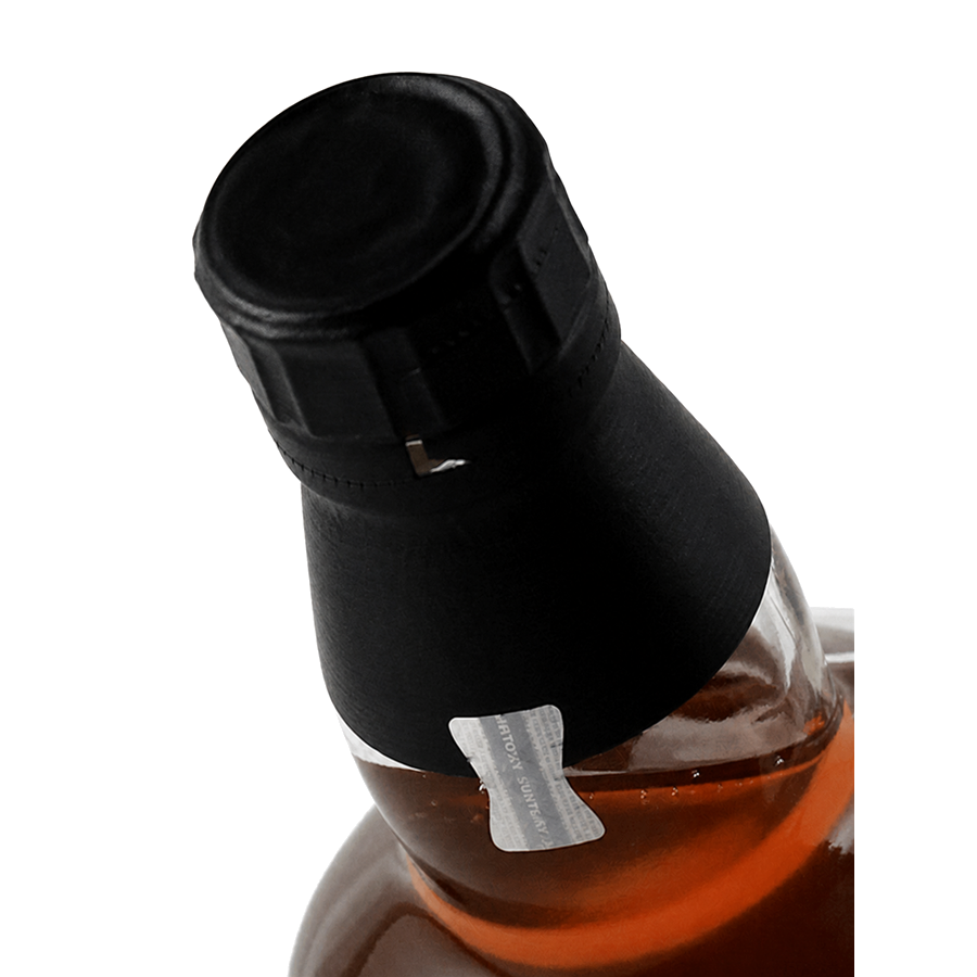 Close-up of a bottle with a black wax-sealed neck and a small silver foil seal, showing amber liquid inside against a white background.